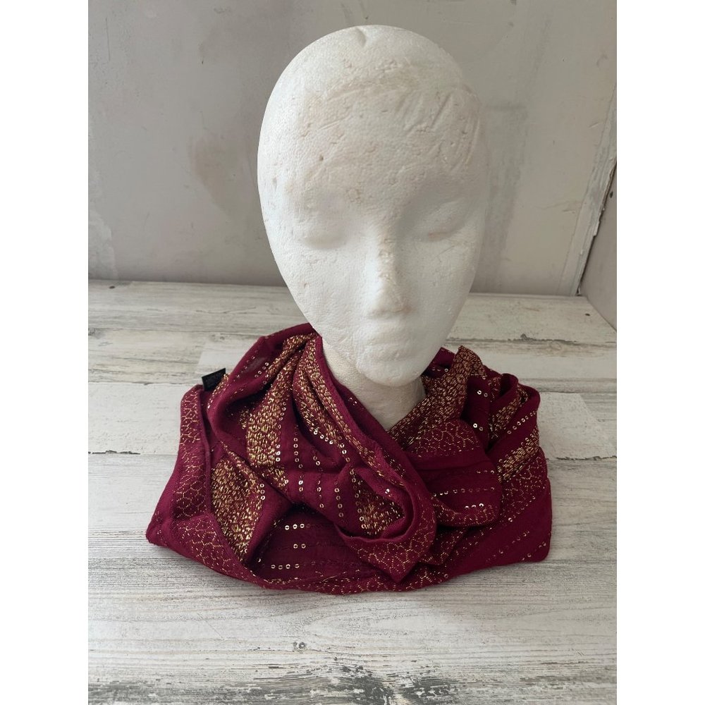 Woman’s burgundy and gold sequined infinity scarf